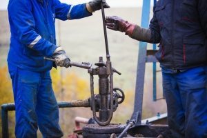 oil workers check oil pump